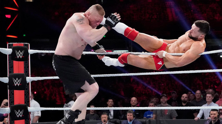 Finn Balor Kicks Brock Lesnar 