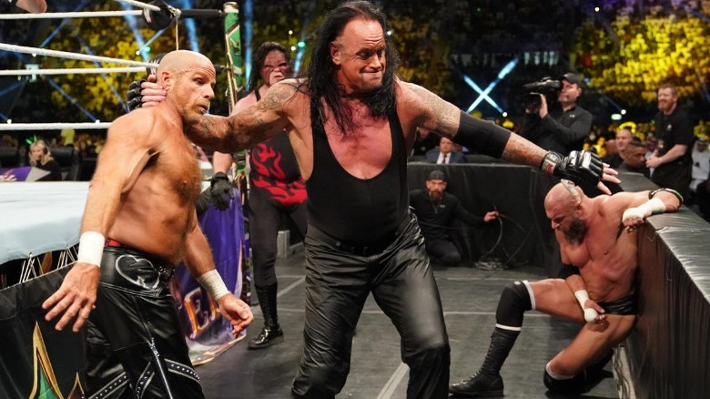 Undertaker grabbing Shawn Michaels