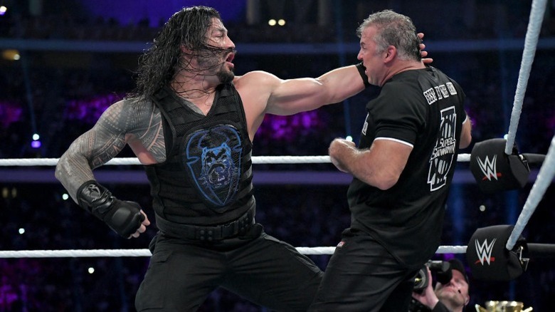 Roman Reigns punching Shane McMahon