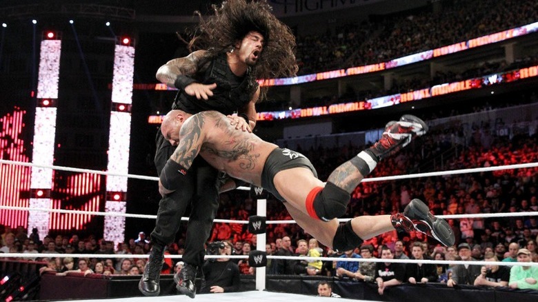 Batista spearing Roman Reigns