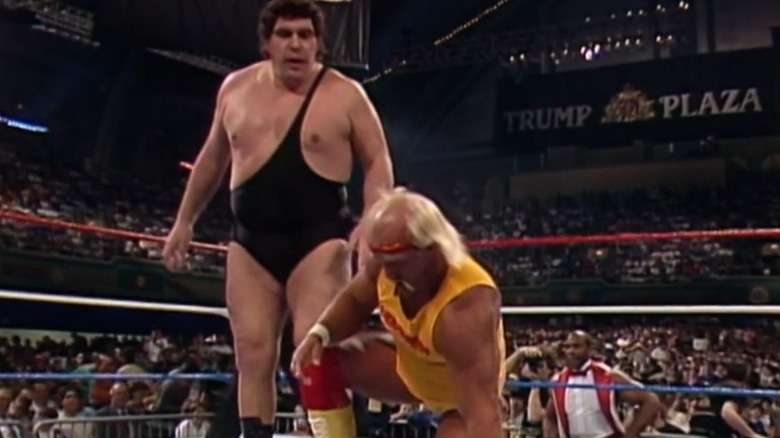 Andre the Giant standing over Hulk Hogan