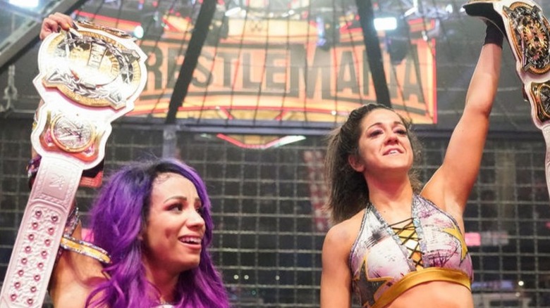 Sasha Banks and Bayley celebrate as the new WWE Women's Tag Team Champions