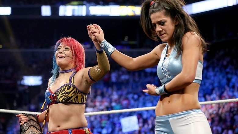 Bayley raises Asuka's hand after being defeated by her at NXT TakeOver: Brooklyn II