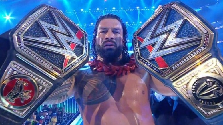 Roman holding both title belts