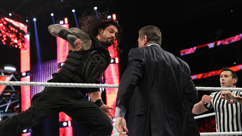 Roman about to punch Vince