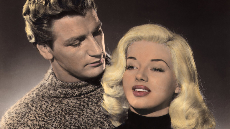 Diana Dors and Joe Robinson embrace