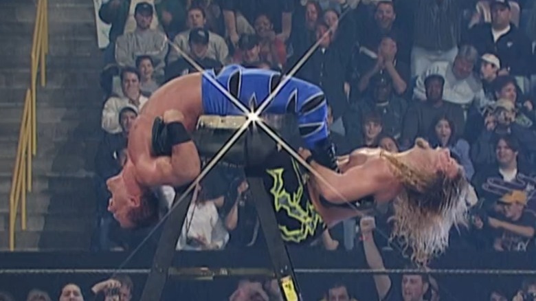 Chris Jericho putting ladder tarantula on Chris Benoit