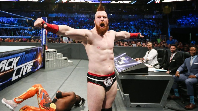 Sheamus stands over Kingston.