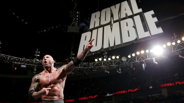 Batista stands on the turnbuckle and points, with Royal Rumble signage in the background, after winning the 2014 Royal Rumble.