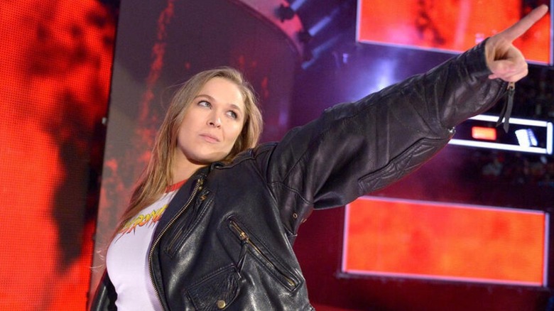 Ronda Rousey appears on the stage during her WWE debut and points to the WrestleMania sign following the Women's Royal Rumble match.