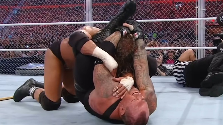 The Undertaker putting Triple H in a submission lock