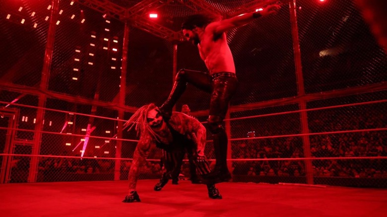 The Fiend and Seth Rollins inside the cell