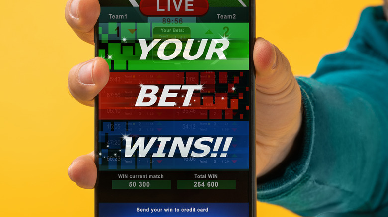 phone screen says 'your bet win!!'
