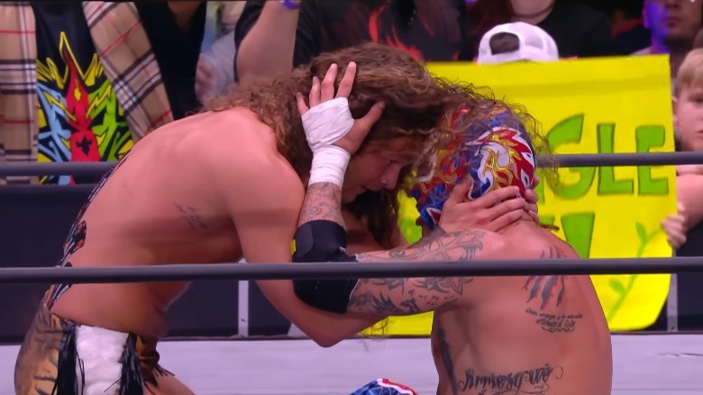 Jungle Boy embracing Rey Fenix