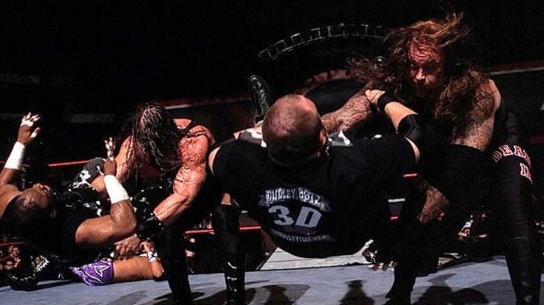 Kane and Undertaker chokeslam the Dudley Boyz