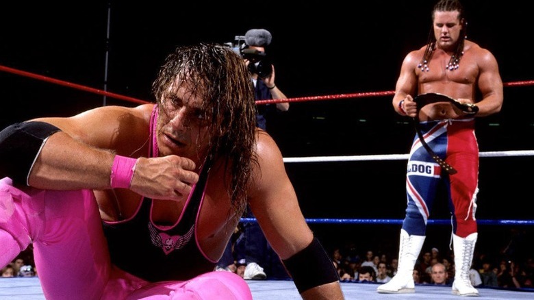 British Bulldog holds belt as Bret Hart sits