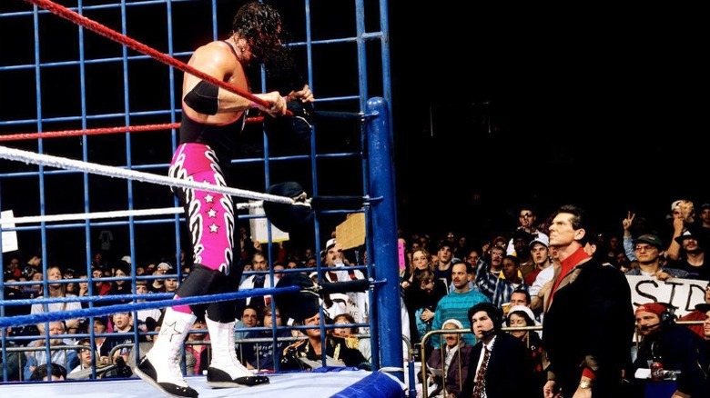 Bret Hart looks down at Vince McMahon