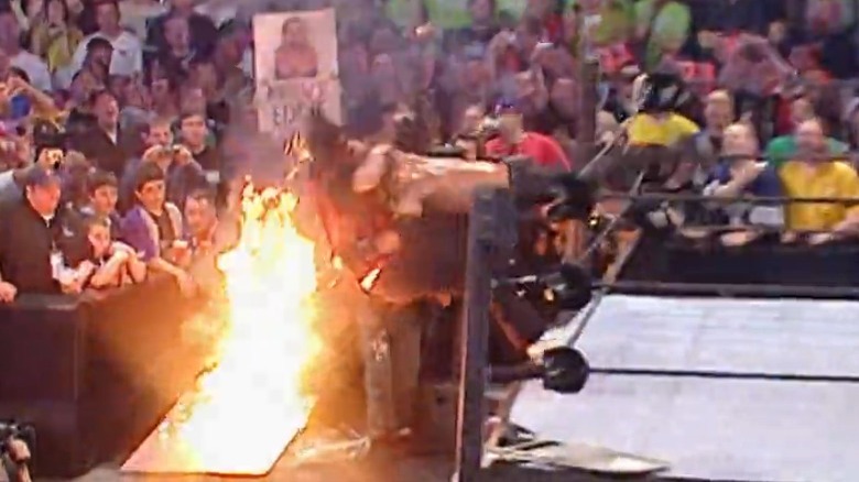 Edge spears Mick Foley through flaming table