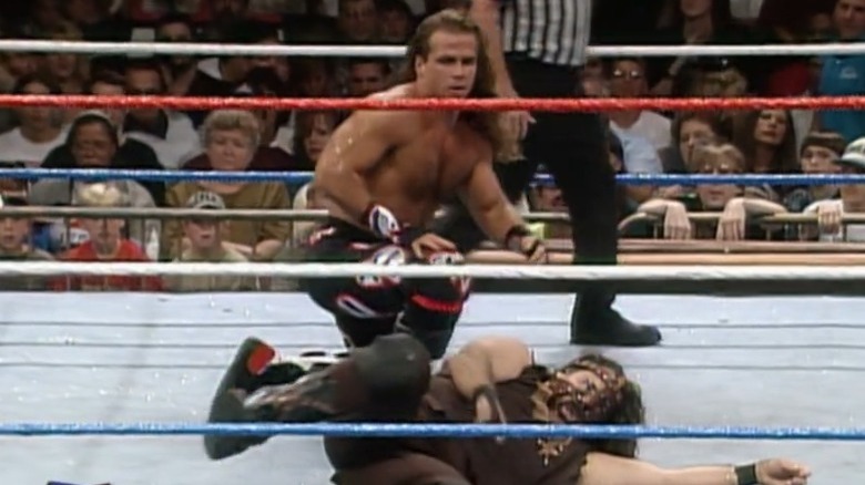 Shawn Michaels crouching over Mankind