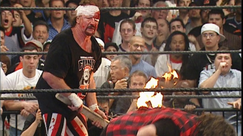 Terry Funk holding flaming two by four