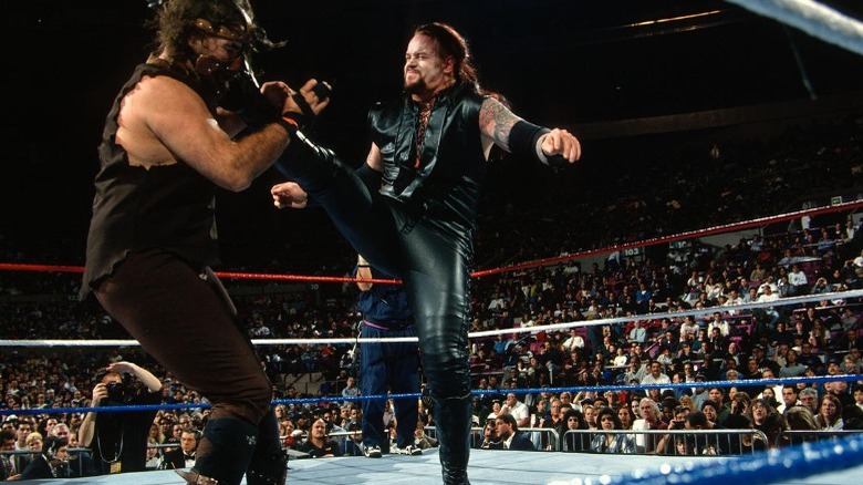 Undertaker giving Mankind a big boot