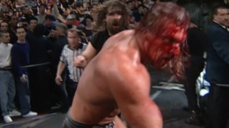 Bloody HHH running from Cactus Jack