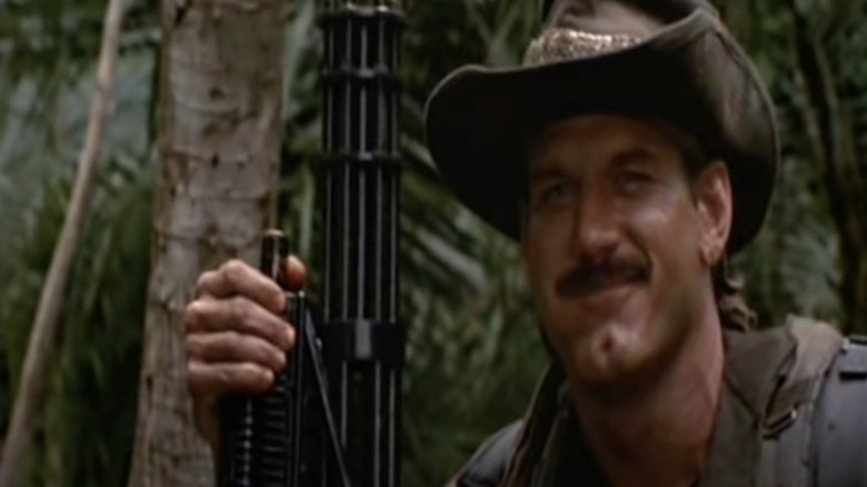 Ventura in Predator holds gun