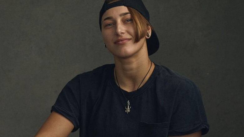 Rhea Ripley poses without makeup in a photoshoot for WWE.com.