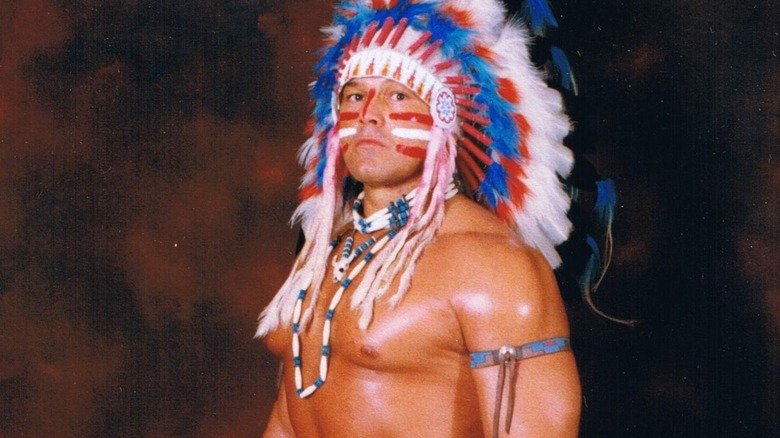 Tatanka poses in traditional Native American headgear and face-paint.