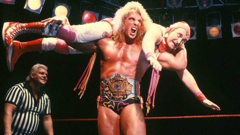 The Ultimate Warrior has Phil Collins in his grasp