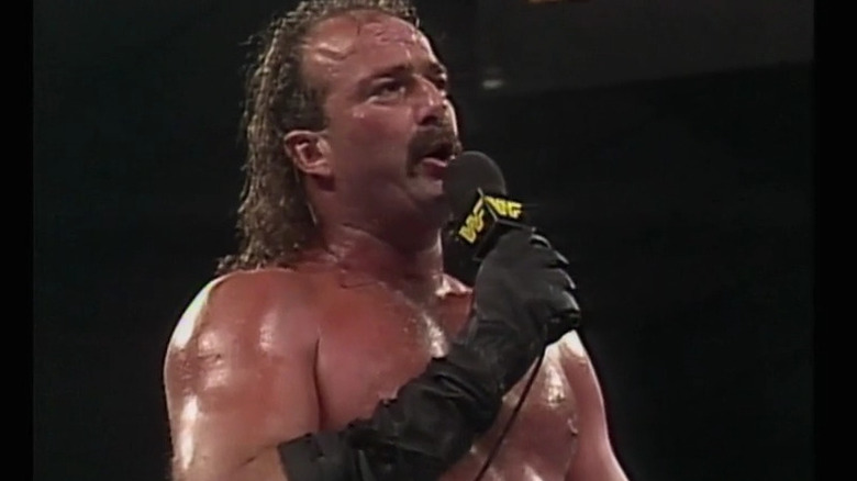 Jake Roberts holds mic