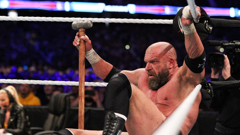 Triple H holds sledgehammer