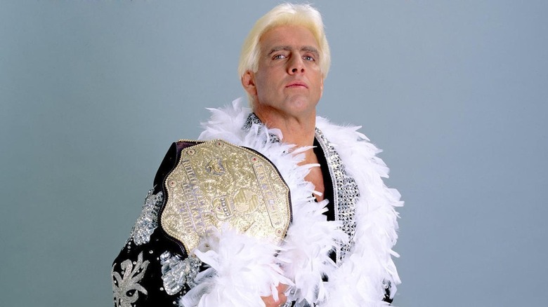 Ric Flair posing with the big gold belt