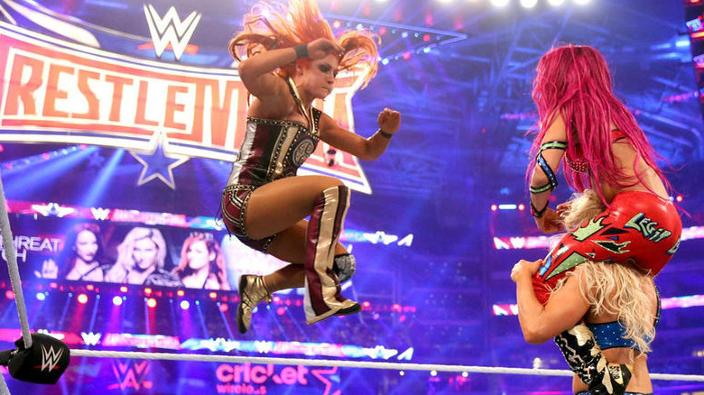 Becky Lynch Jumping Towards Sasha Banks on Charlotte Flair's Shoulders 