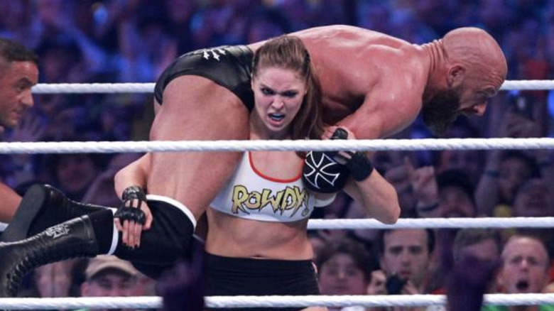 Ronda Rousey lifting up Triple H