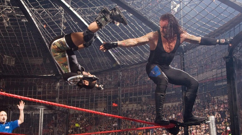 Undertaker throwing MVP off of an Elimination Chamber pod