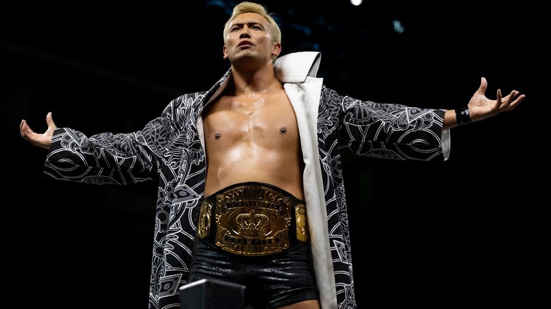 Kazuchika Okada spreads his arms as the AEW Continental Championship hangs proudly around his waist.