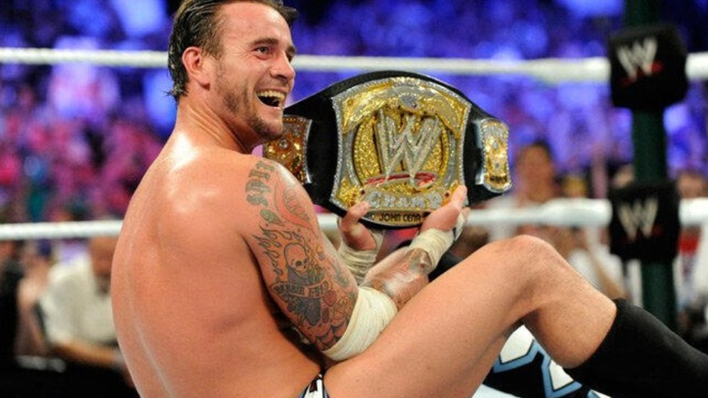 CM Punk holds up the WWE Championship after winning it from John Cena in his hometown of Chicago.