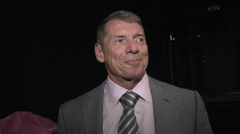 Vince McMahon smirking awkwardly.