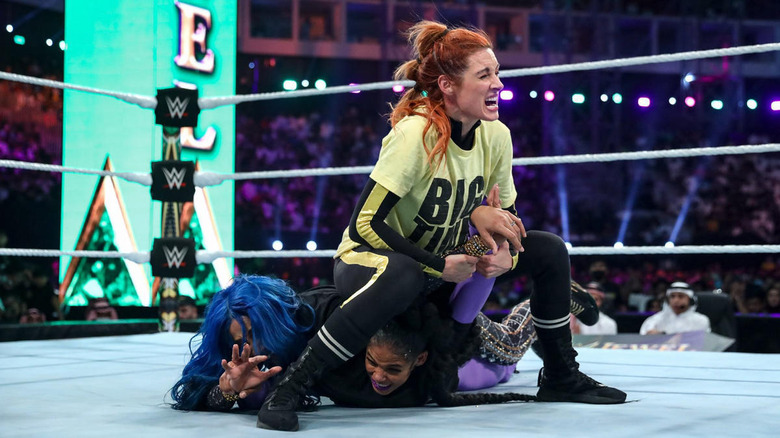 Becky holds Bianca and Sasha in a submission