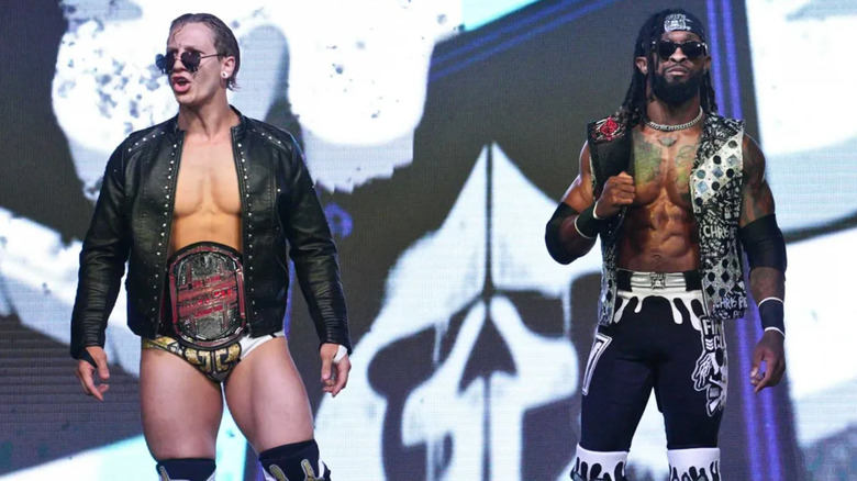 Ace Austin and Chris Bey wearing Impact Tag Team Championships