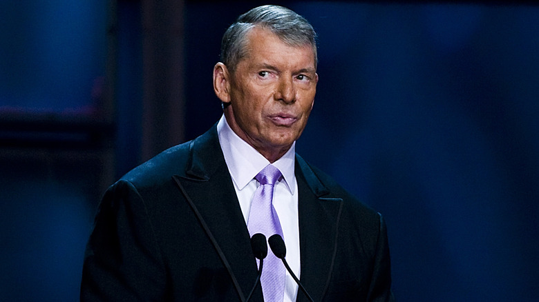 Vince McMahon looks on before giving a speech