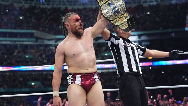 Bryan Danielson raising world title belt