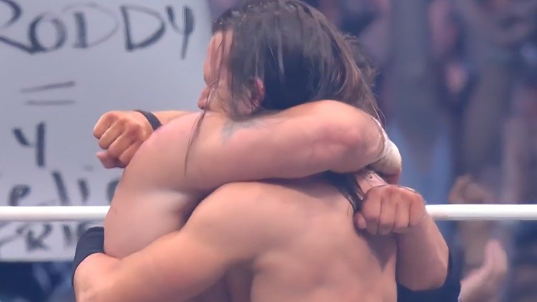 Adam Cole hugging MJF