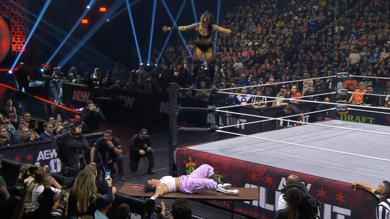 Statlander looking to land a Swanton Bomb on Nightingale through a table