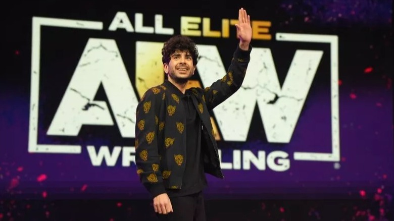 Tony Khan waves to the crowd during an AEW live event