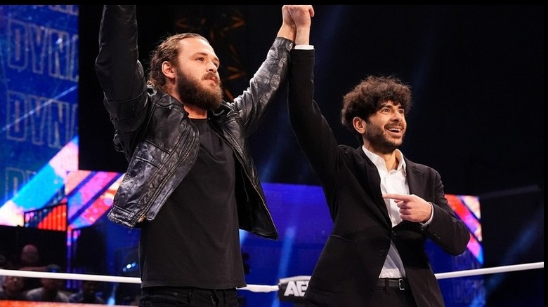 Jack Perry and Tony Khan celebrate together in the ring before Perry attacks him