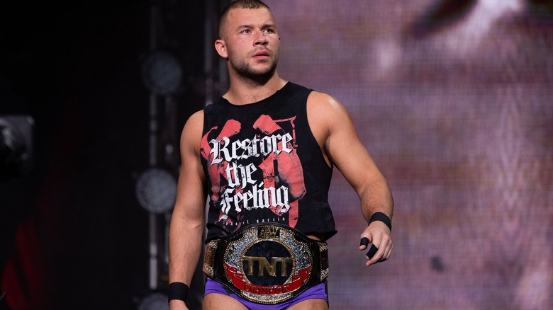 TNT Champion Daniel Garcia walks out on stage, belt around his wais