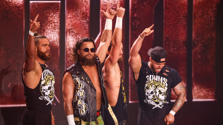 Bullet Club Gold with finger guns in the air