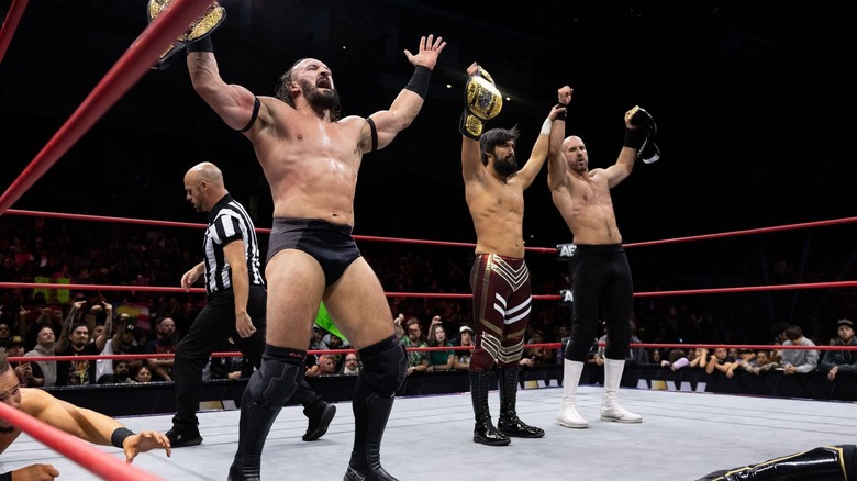 PAC, Wheeler Yuta, and Claudio Castagnoli raise their AEW World Trios titles high on "Collision"